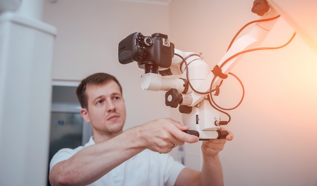 Microscope with photo camera in the dental office