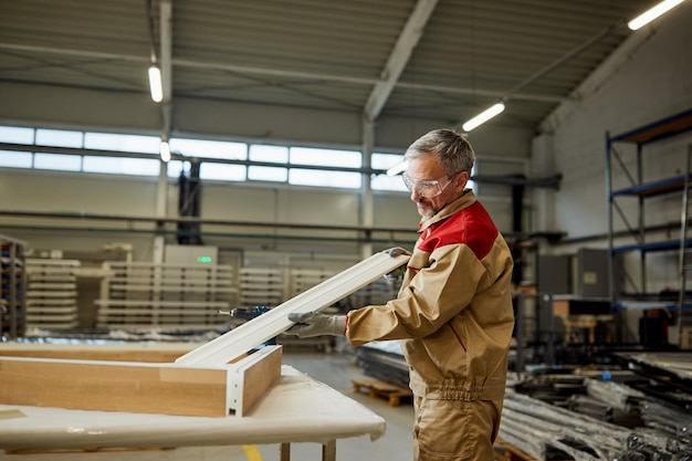 Mid adult craftsman working at carpentry workshop