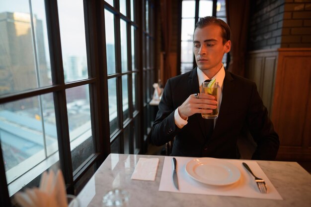 Mid adult man holding glass window