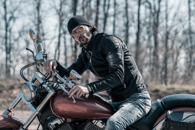 写真 森のオートバイに座っている中年男性