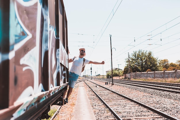 mid adult man standing on train against sky