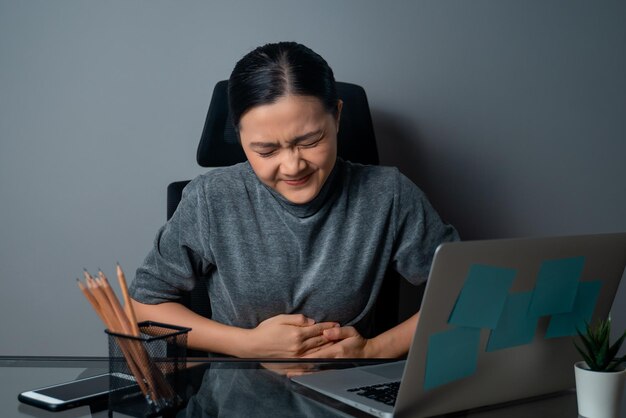 Mid adult man using mobile phone while sitting on table