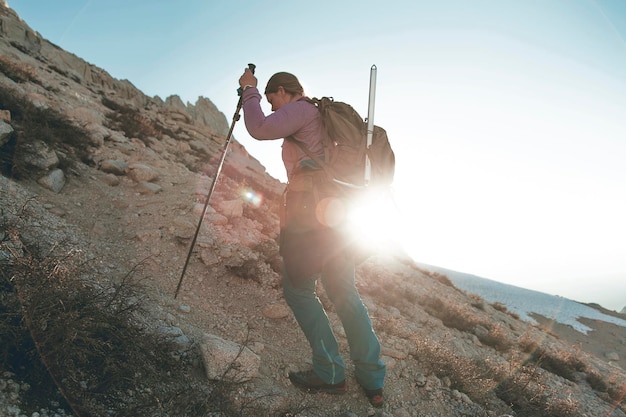 mid adult woman hiking on mountain against sky