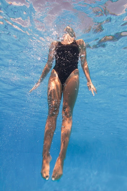 Mid adult woman swimming in pool