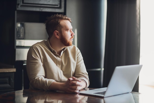 Mid age man working on laptop at home