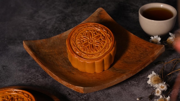 Mid autumn moon cakes and tea on grey rustic background Concept of Chinese traditional food and dessert