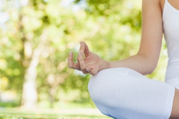 Mid section of calm young woman meditating 