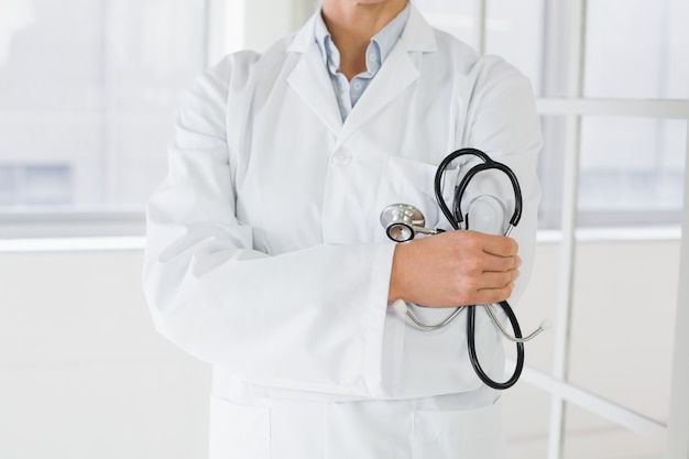 Mid section of a female doctor with stethoscope in hospital