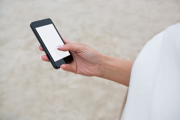 Mid section of woman using mobile phone