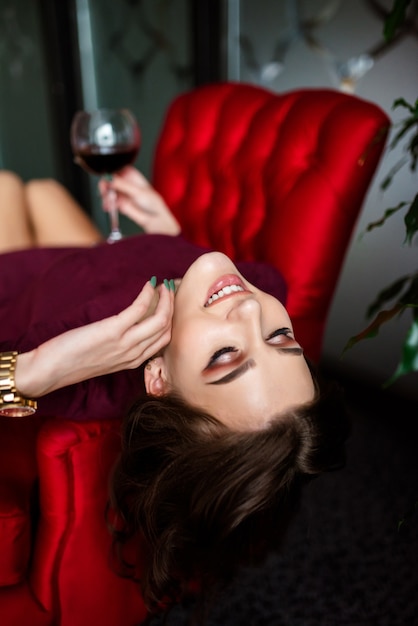 Mid shot of an inspired woman enjoying a glass of red wine