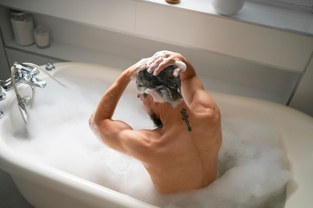 Foto middelgrote man die in bad gaat