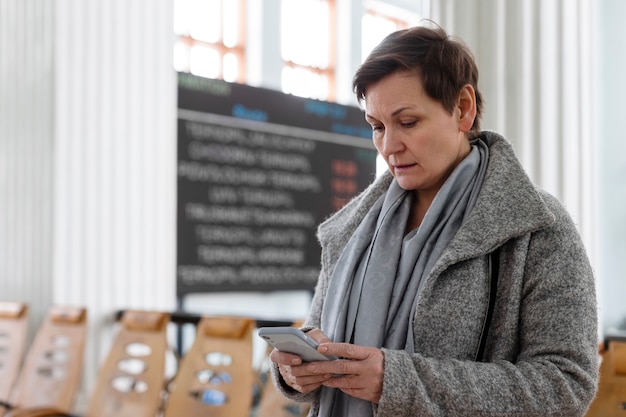 Middelgrote vrouw met een smartphone.