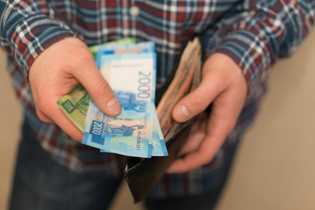 Foto middelsectie van een man met een portemonnee met papieren munten