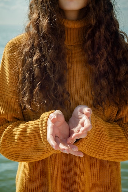 Middelsectie van vrouw die buiten een trui draagt