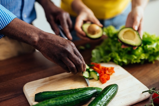 Middelsnede van een man die eten bereidt op een snijplank
