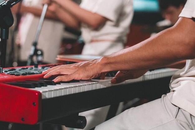 Middelsnede van een man die piano speelt