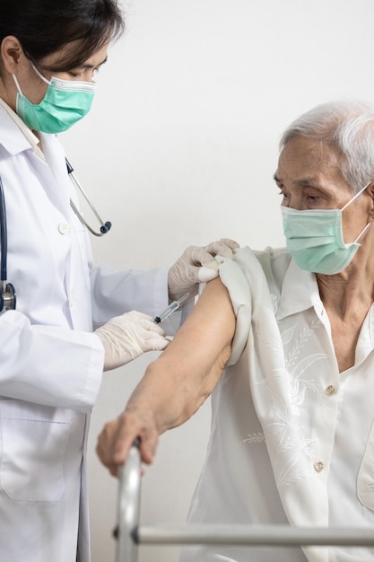 Middelsnede van een man met opgeheven armen die tegen de muur staat
