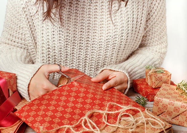 Middelsnede van een vrouw die thuis een geschenk inpakt