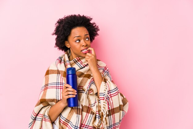 Middle age african american woman in a camping isolatedrelaxed thinking about something looking at a copy space.