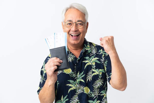 Middle age Brazilian man isolated on white background happy in vacation with passport and plane tickets