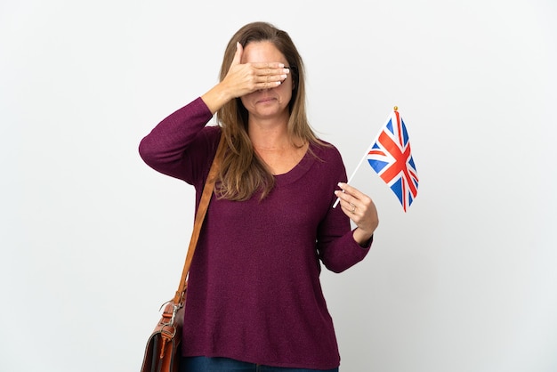 Middle age  Brazilian woman holding an United Kingdom flag isolated