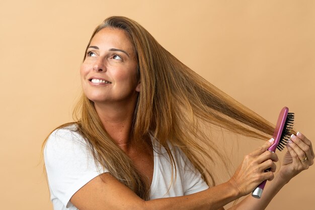 Middle age brazilian woman isolated with hair comb