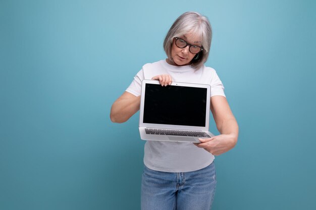 Middle age business a middleaged woman with gray hair masters a remote profession on a computer in a