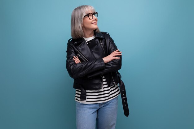 Middle age business s mature woman in gray hair looking great in stylish look on blue background