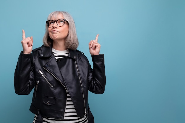 Middle age business s mature woman in gray hair looking great in stylish look on bright background