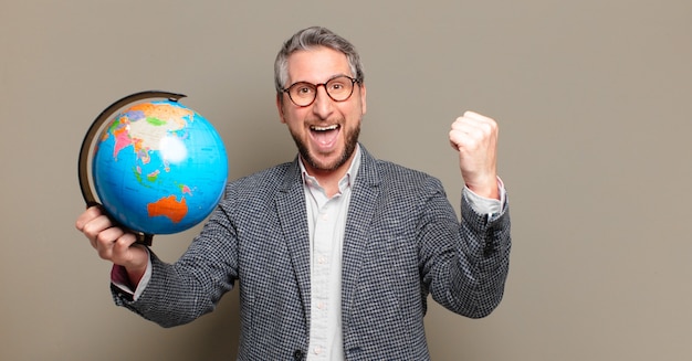 Middle age businessman with a world globe map