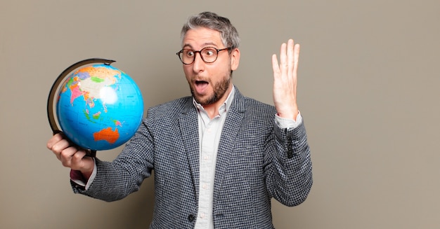 Middle age businessman with a world globe map