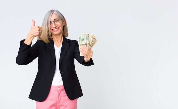 Middle age businesswoman with dollar bills