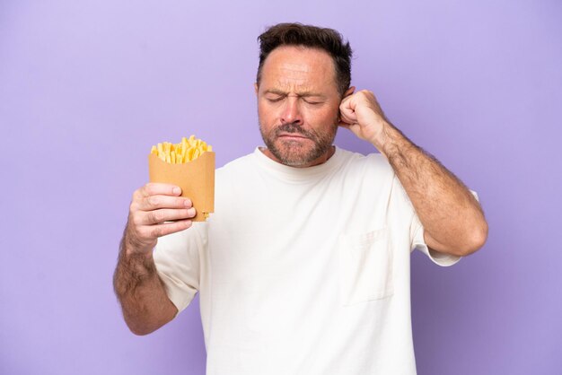 Middle age caucasian man holding fried chips