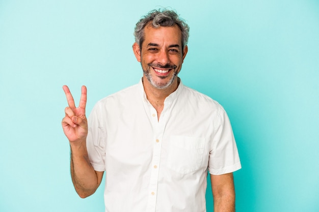 Middle age caucasian man isolated on blue background  showing number two with fingers.