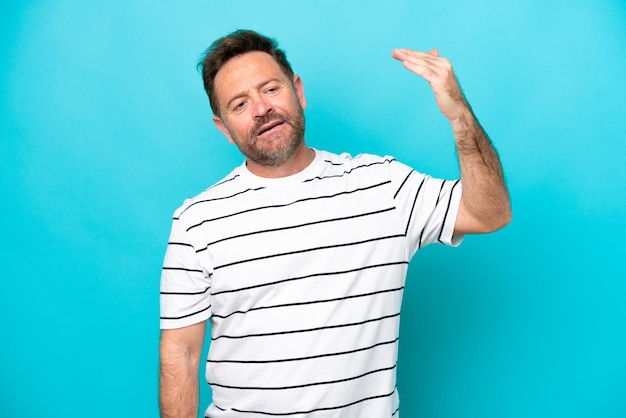 Middle age caucasian man isolated on blue background with tired and sick expression