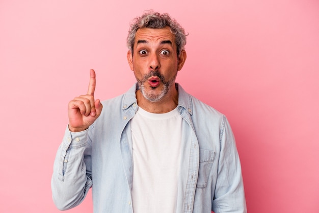 Middle age caucasian man isolated on pink background  having an idea, inspiration concept.