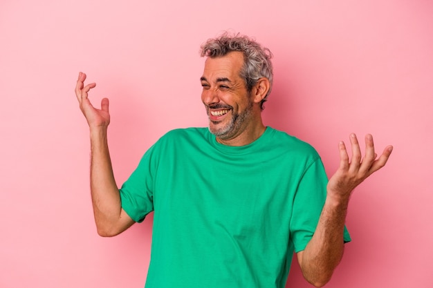 Middle age caucasian man isolated on pink background  joyful laughing a lot. Happiness concept.