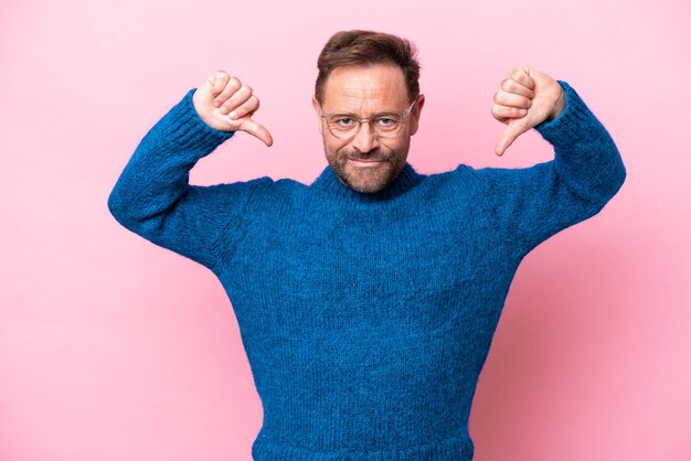 Middle age caucasian man isolated on pink background proud and selfsatisfied