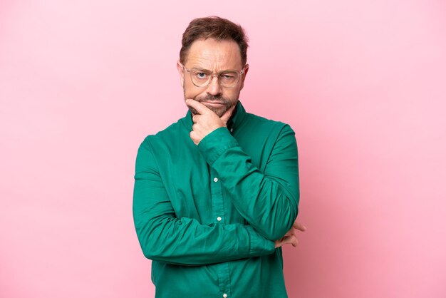 Middle age caucasian man isolated on pink background