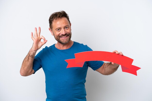 Middle age caucasian man isolated on white background holding an empty placard and doing OK sign