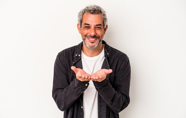 Middle age caucasian man isolated on white background  holding something with palms, offering to camera.