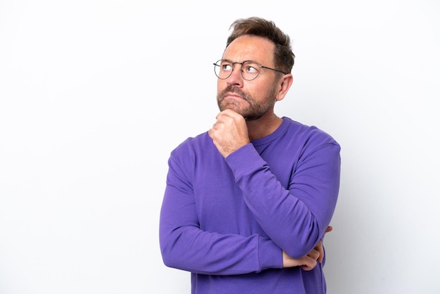 Middle age caucasian man isolated on white background and looking up