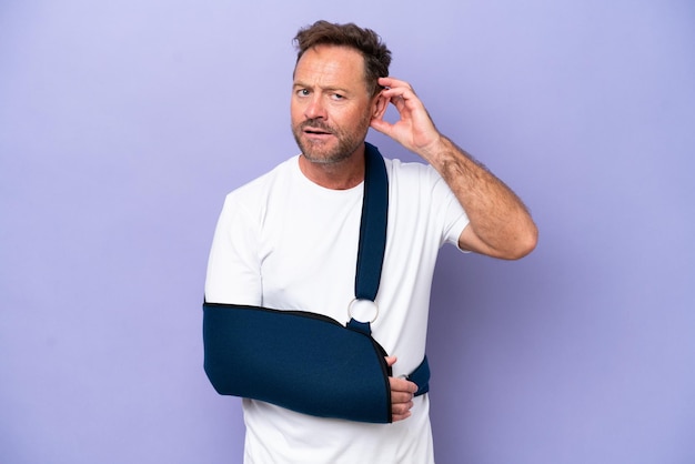 Middle age caucasian man with broken arm and wearing a sling