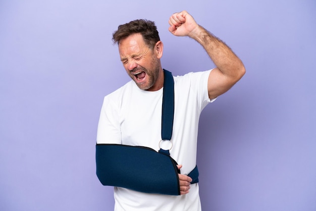 Middle age caucasian man with broken arm and wearing a sling