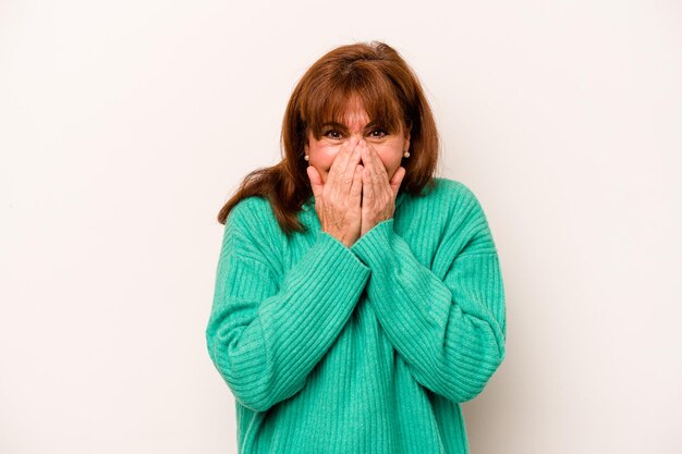 Middle age caucasian woman isolated on white background laughing about something covering mouth with hands