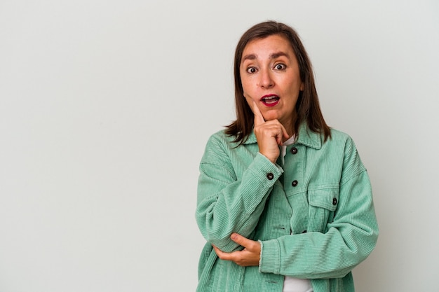 Middle age caucasian woman isolated on white background looking sideways with doubtful and skeptical expression.