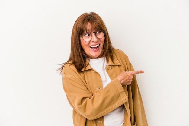 Middle age caucasian woman isolated on white background looks aside smiling, cheerful and pleasant.