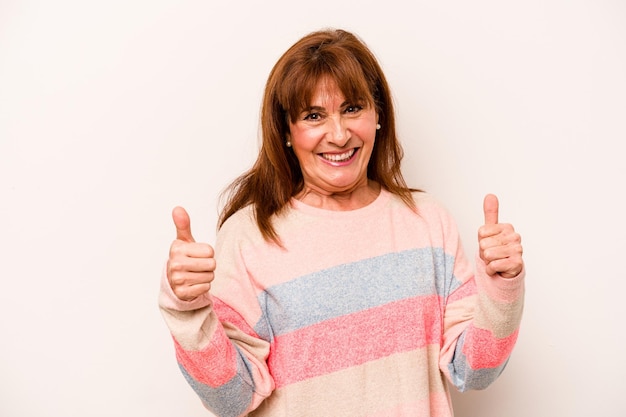 Middle age caucasian woman isolated on white background raising both thumbs up smiling and confident