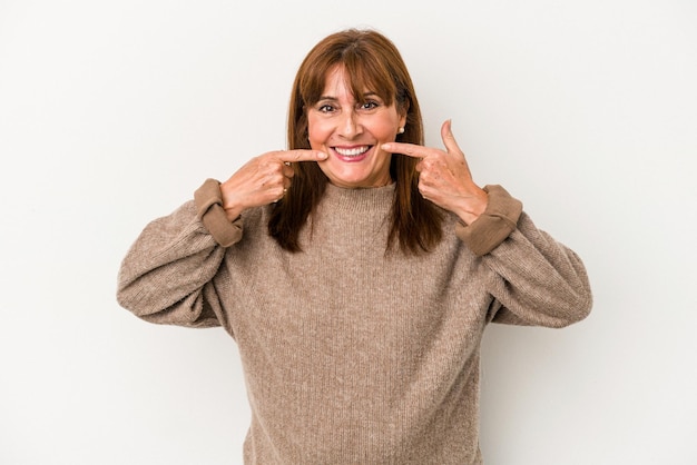 Middle age caucasian woman isolated on white background smiles, pointing fingers at mouth.