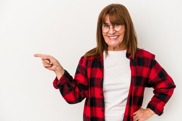 Middle age caucasian woman isolated on white background smiling cheerfully pointing with forefinger away.